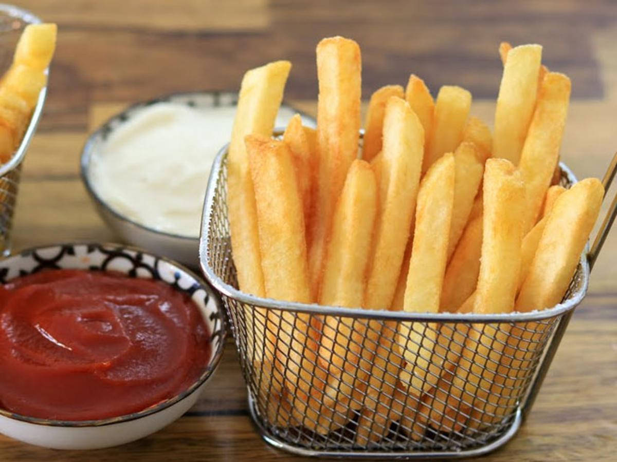 Delectable Golden French Fries In A Basket Background