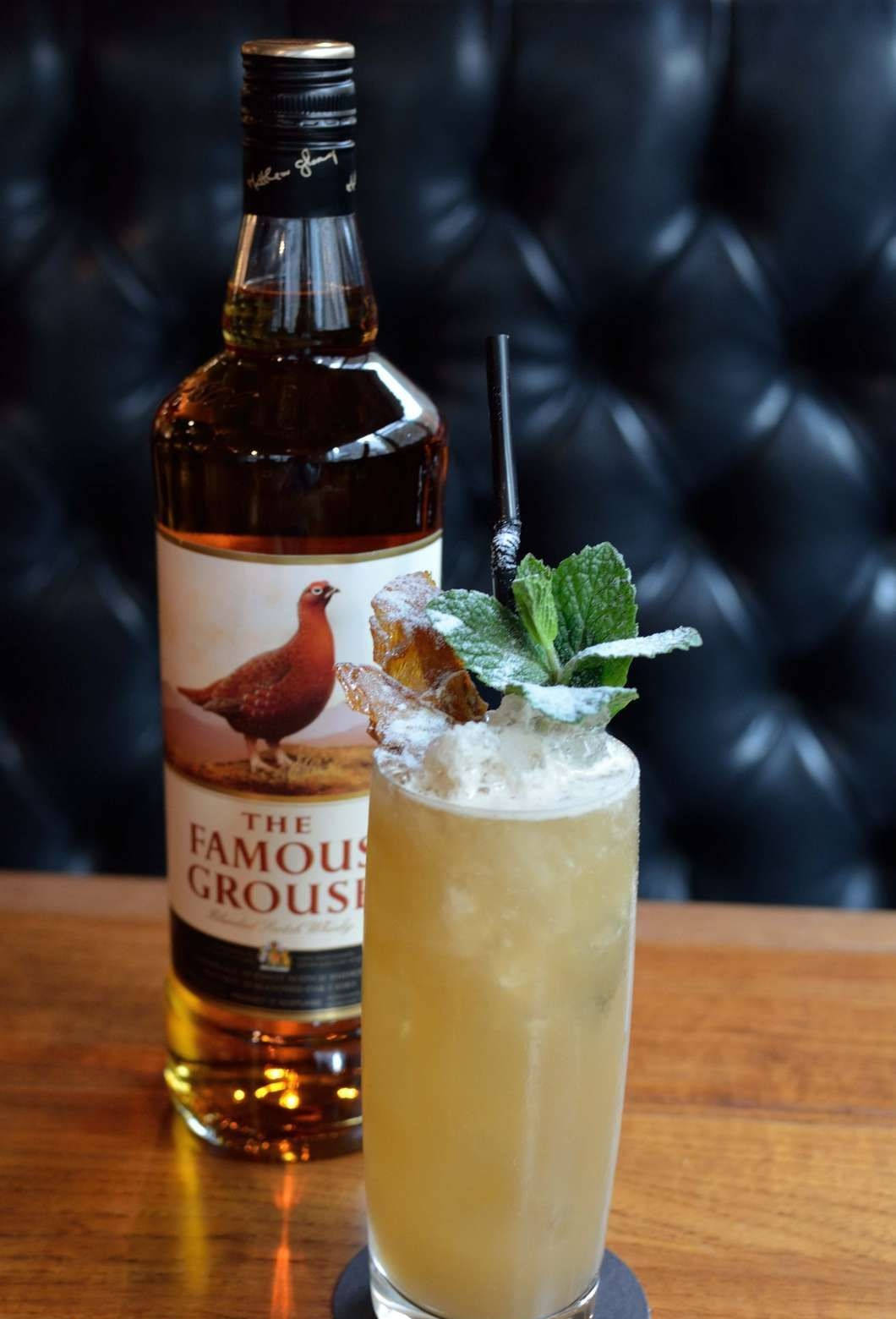 Delectable Penicillin Cocktail With Famous Grouse Whiskey Background