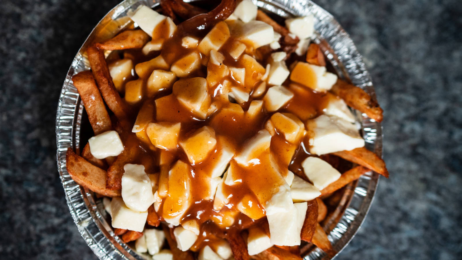 Delectable Poutine Plate - Canadian Signature Snack Background