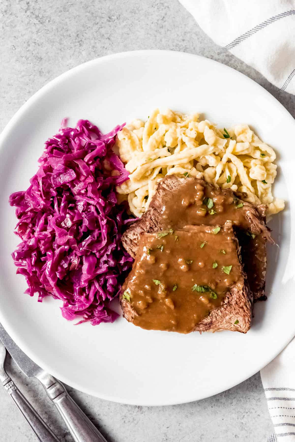 Delectable Sauerbraten Dish With Red Cabbage And Spaetzle Background