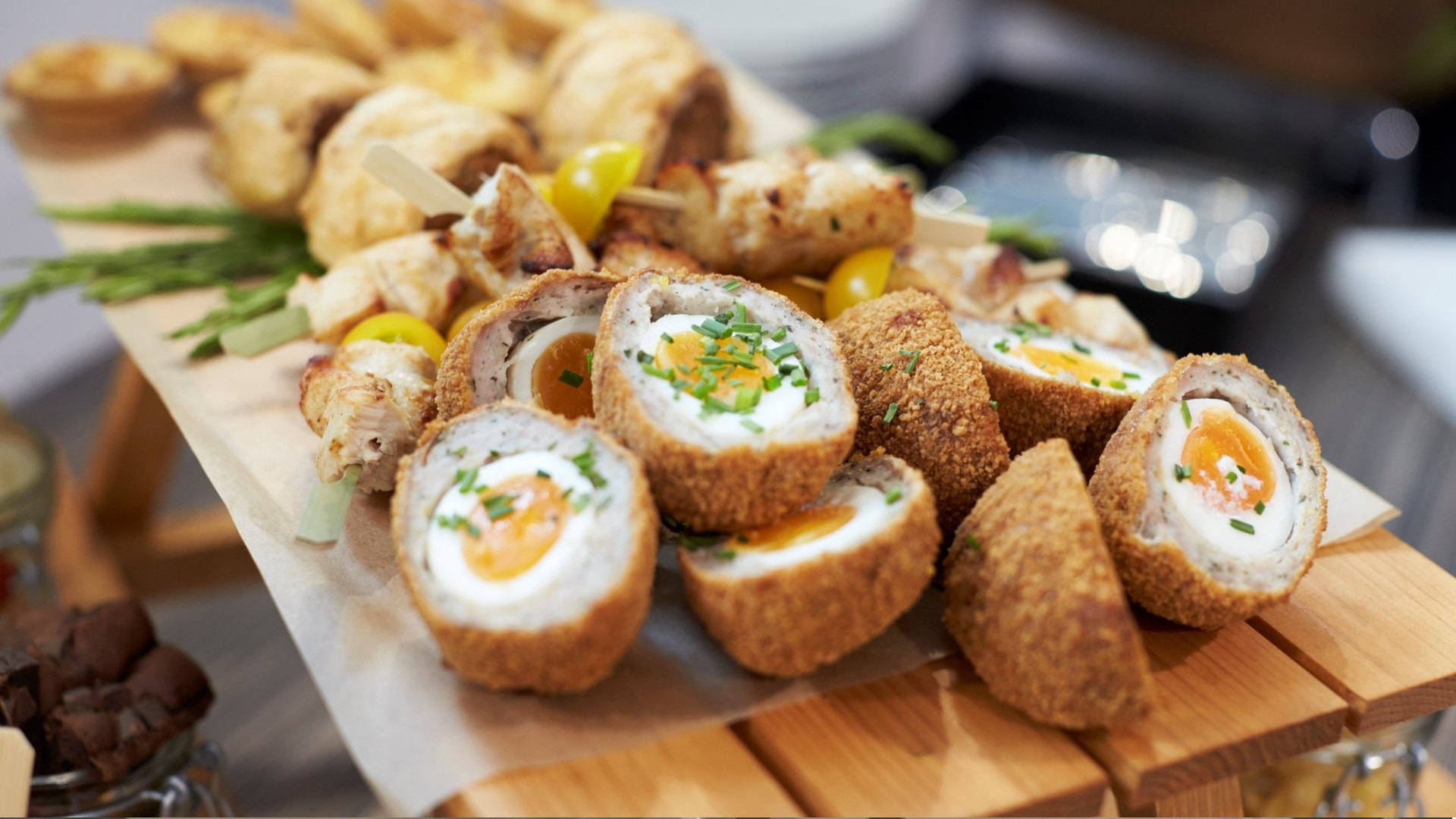 Delectable Traditional British Scotch Eggs With Sausage Rolls Background