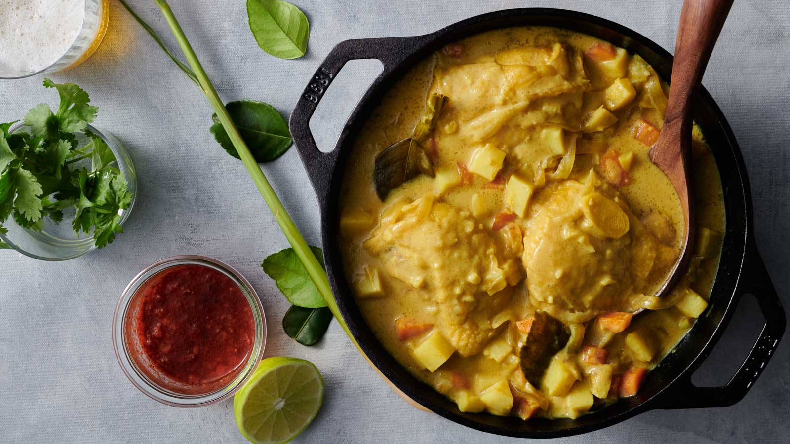 Delectable Yellow Curry In A Pot Garnished With Fresh Coriander Leaves