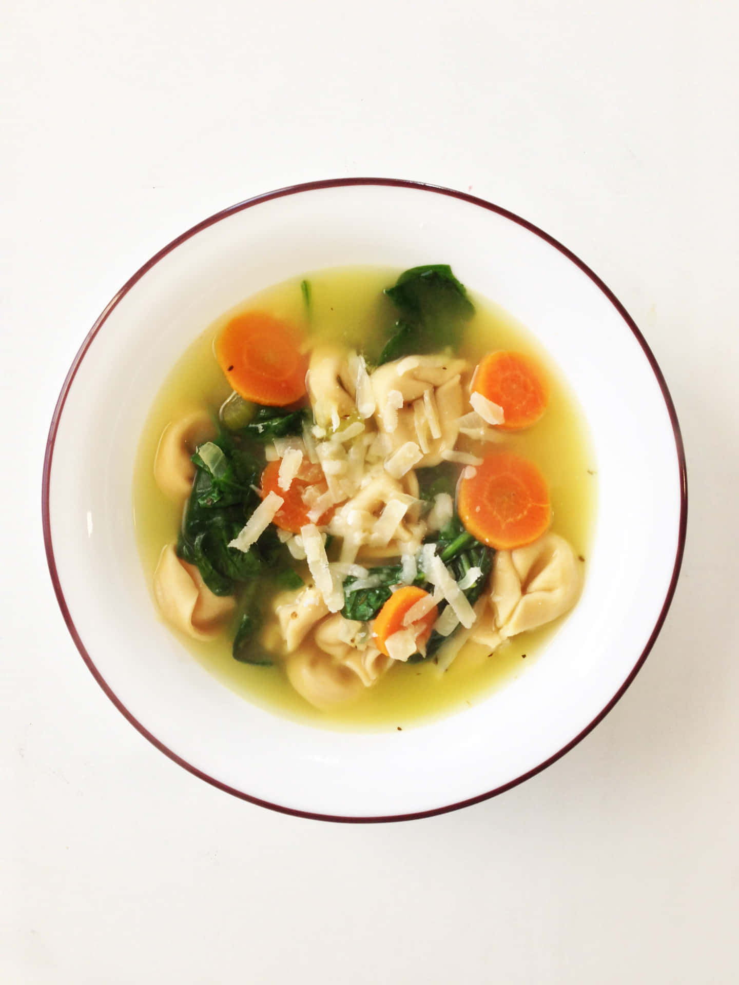 Delicate Tortellini In Brodo With Carrots And Spinach Background