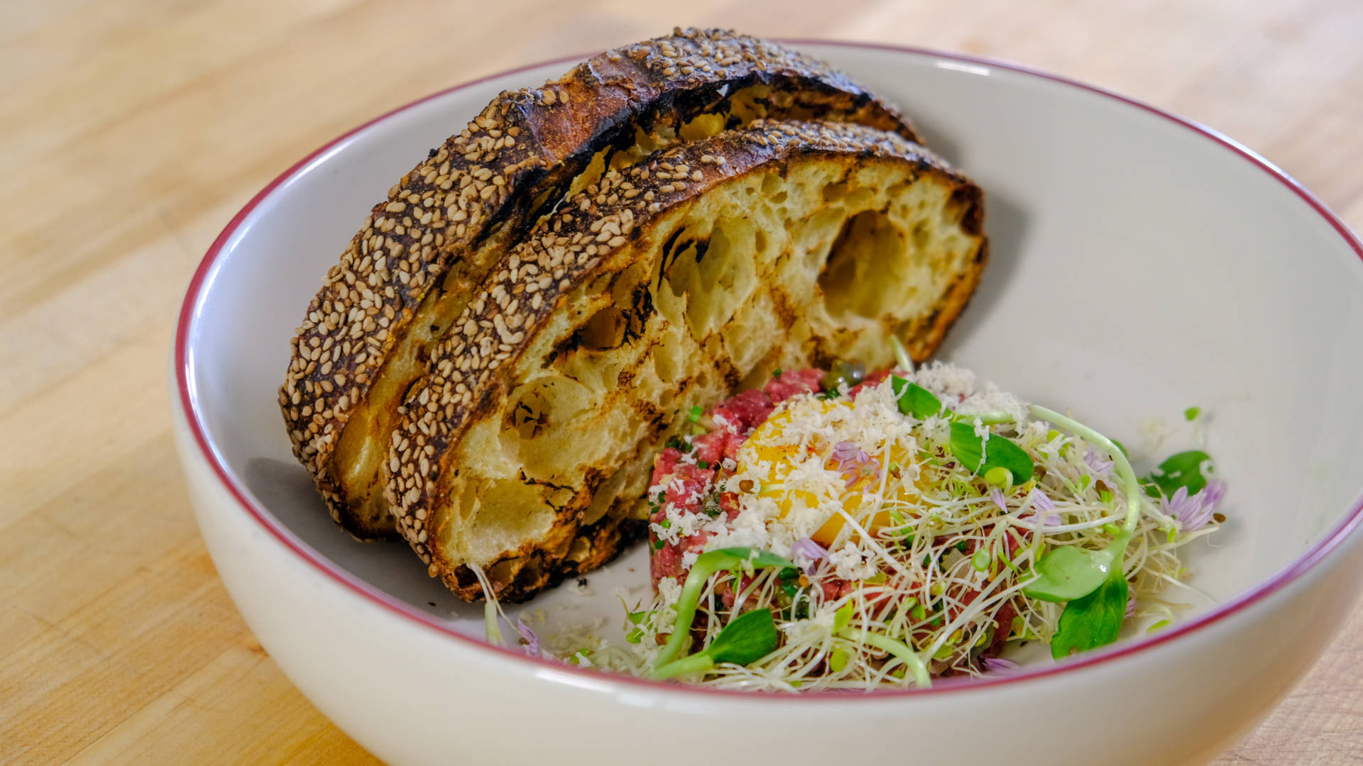 Delicately Prepared Steak Tartare With Vibrant Salad Background