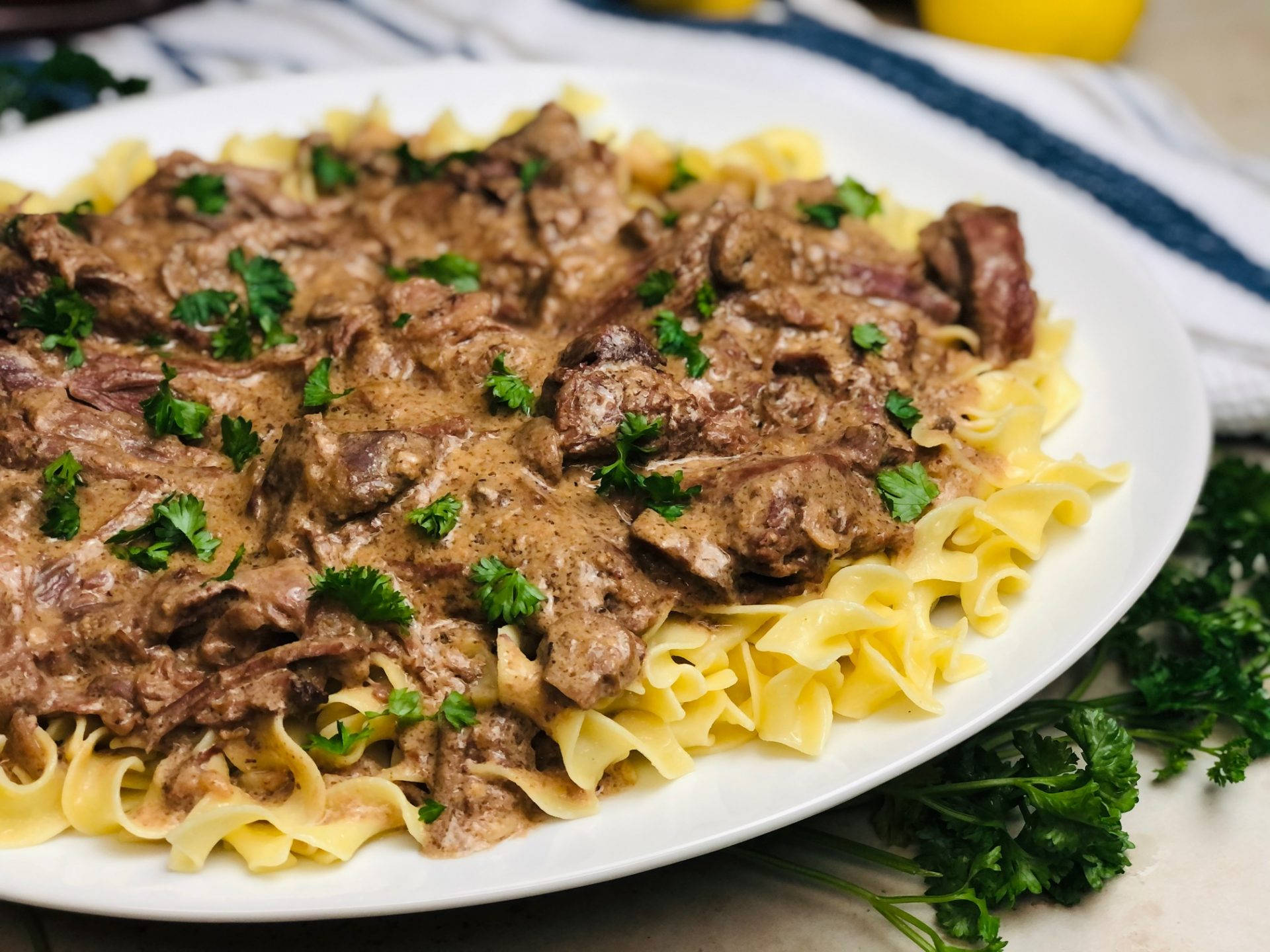 Delicious Beef Stroganoff Served Over Reginette Pasta Background