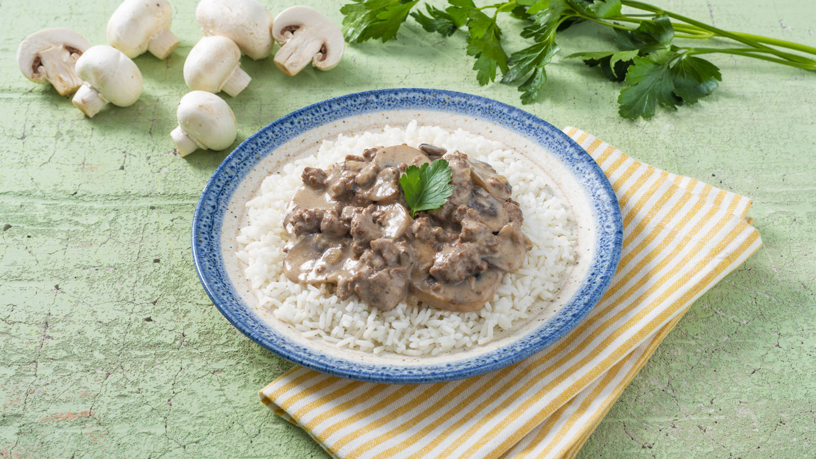 Delicious Beef Stroganoff With Mushrooms Served Over Rice Background