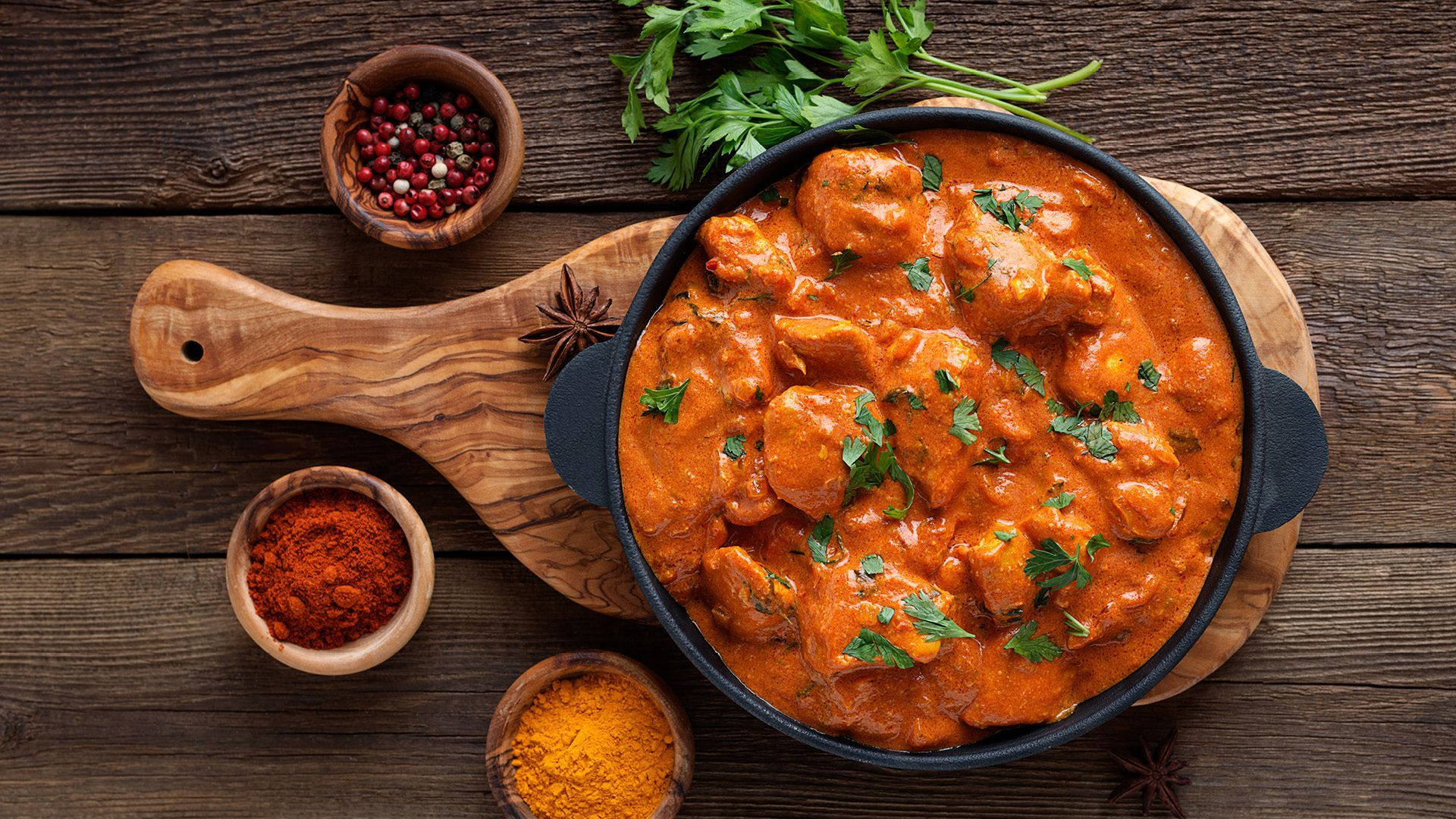 Delicious Butter Chicken Served In An Iron Pan Background