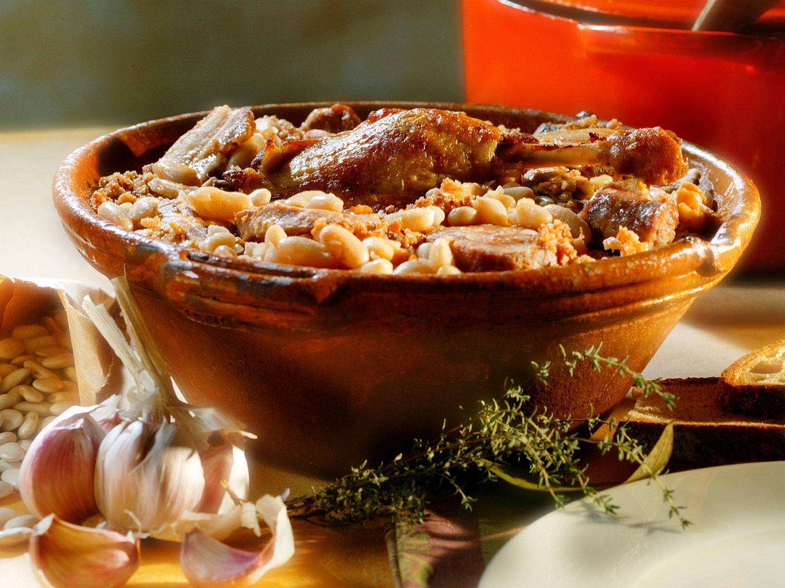 Delicious Cassoulet French Dish Surrounded By Herbs And Spices Background