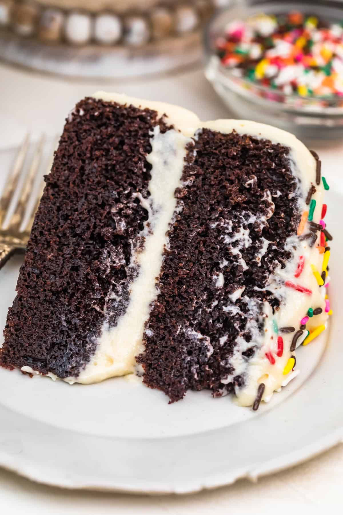 Delicious Chocolate Cake Slice With White Icing Background