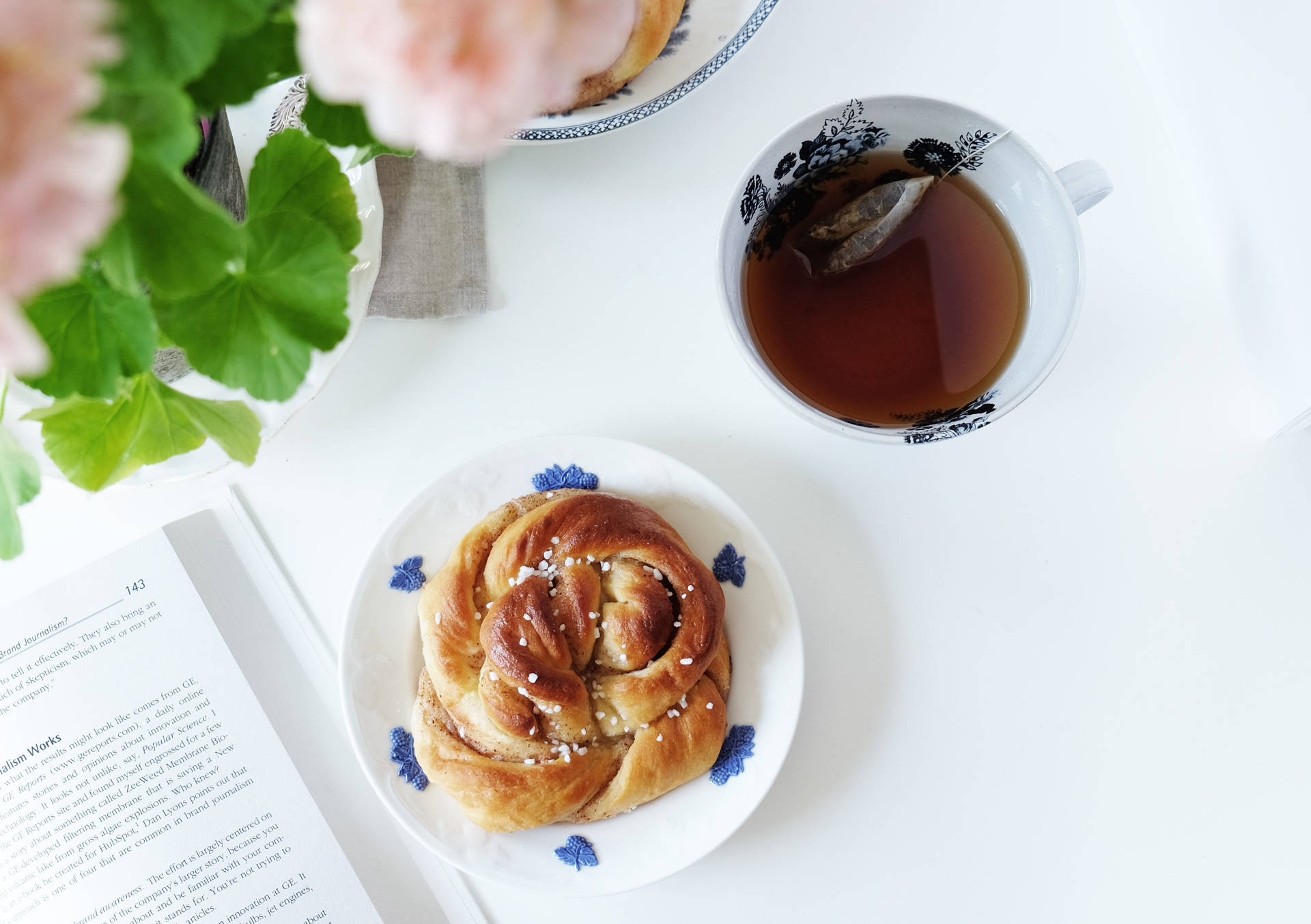 Delicious Cinnamon Bun Paired With Afternoon Tea Background