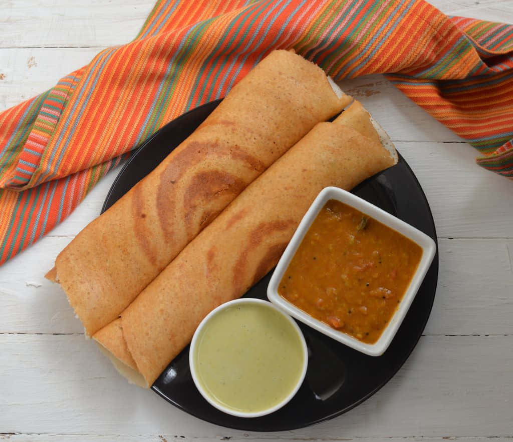 Delicious Crispy Golden Dosa Served Hot Background