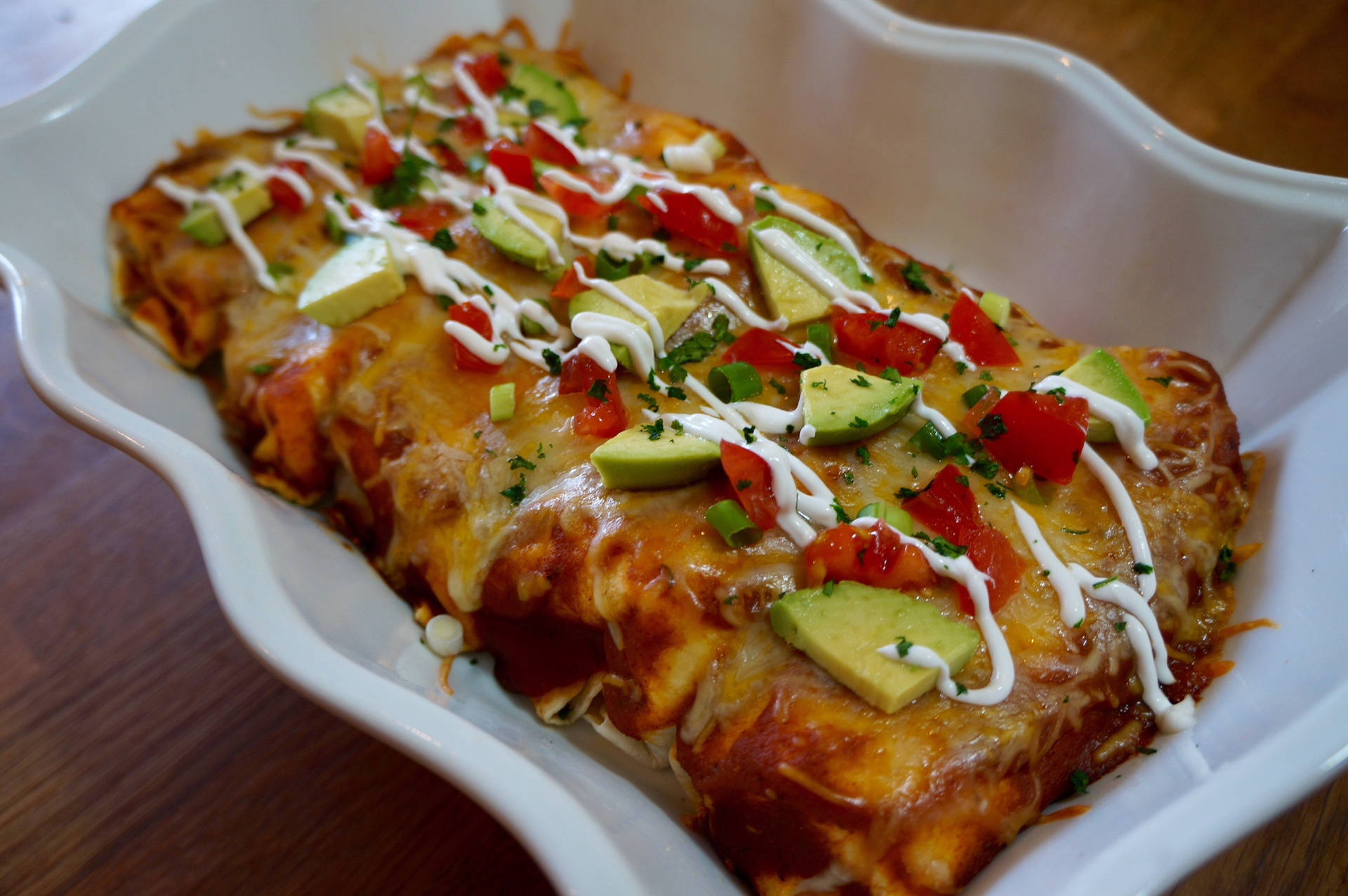 Delicious Enchiladas Topped With Fresh Avocado And Tomato