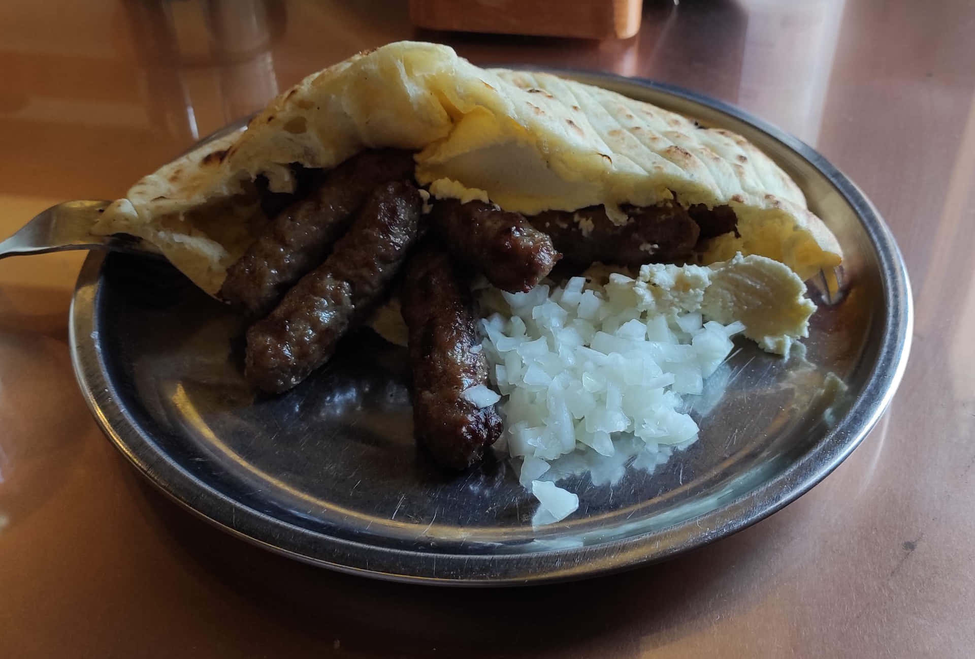 Delicious Grilled Ćevapi Inside Crisp Pita Bread Background