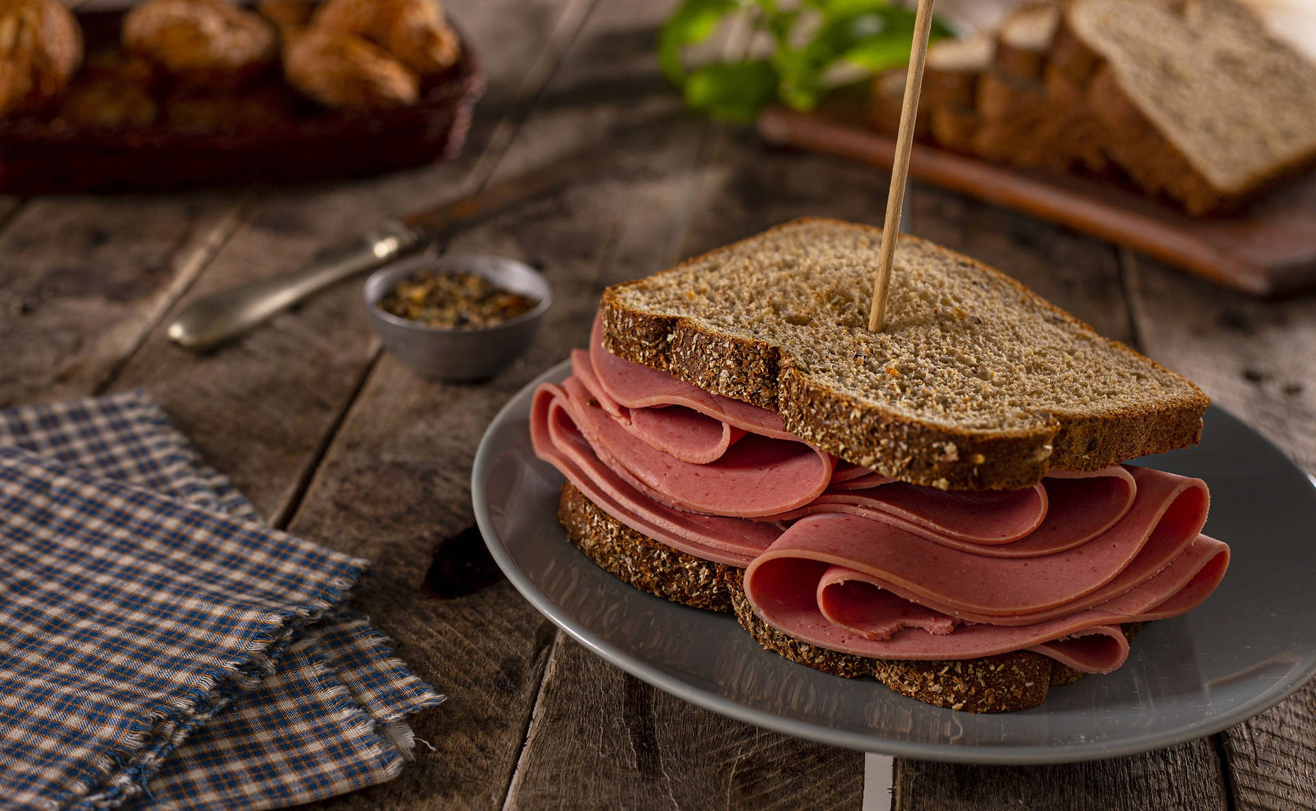Delicious Ham Sandwich On Brown Bread Background