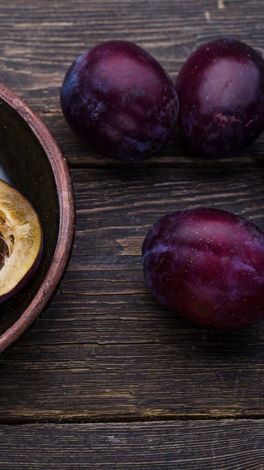 Delicious Italian Prune Blood Plums Against A Dark Background Background