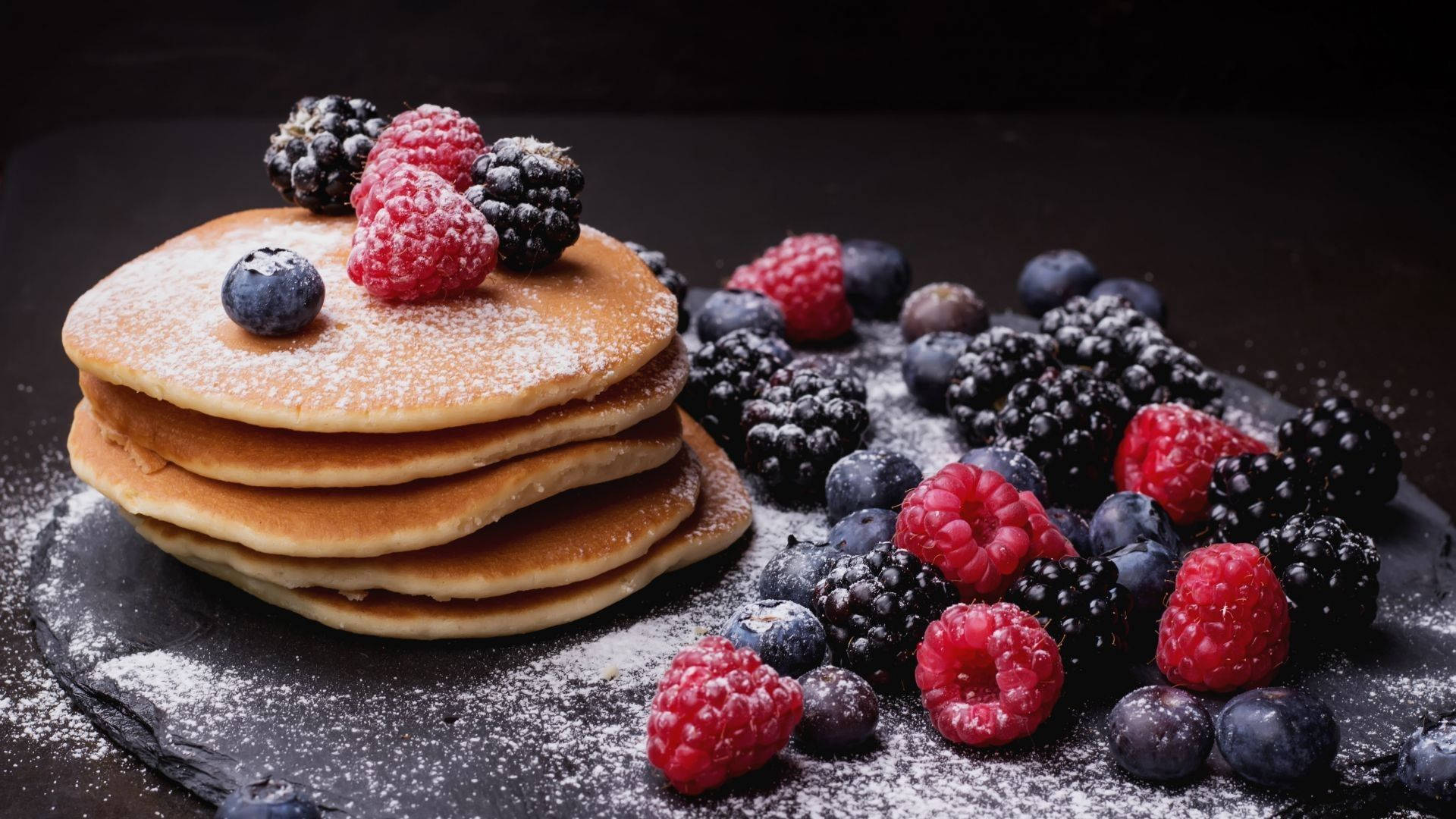 Delicious Pancakes Topped With Sugar And Berries