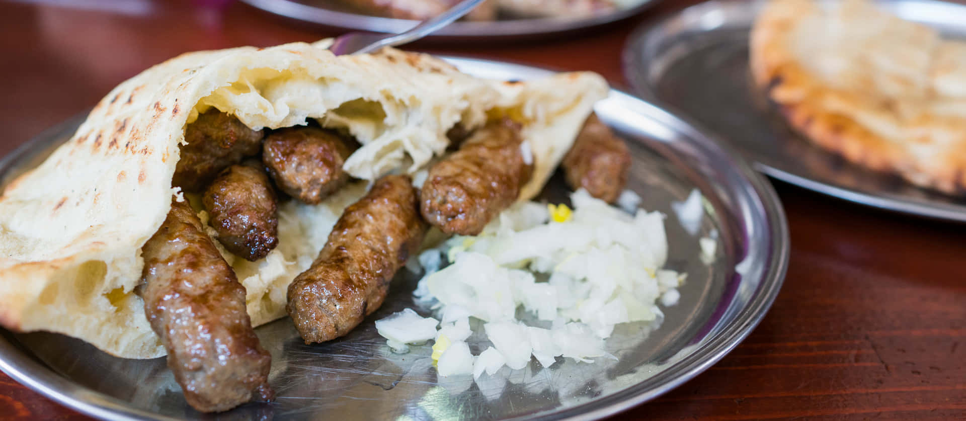 Delicious Pita Bread Stuffed With Cevapi And Fresh Onions Background