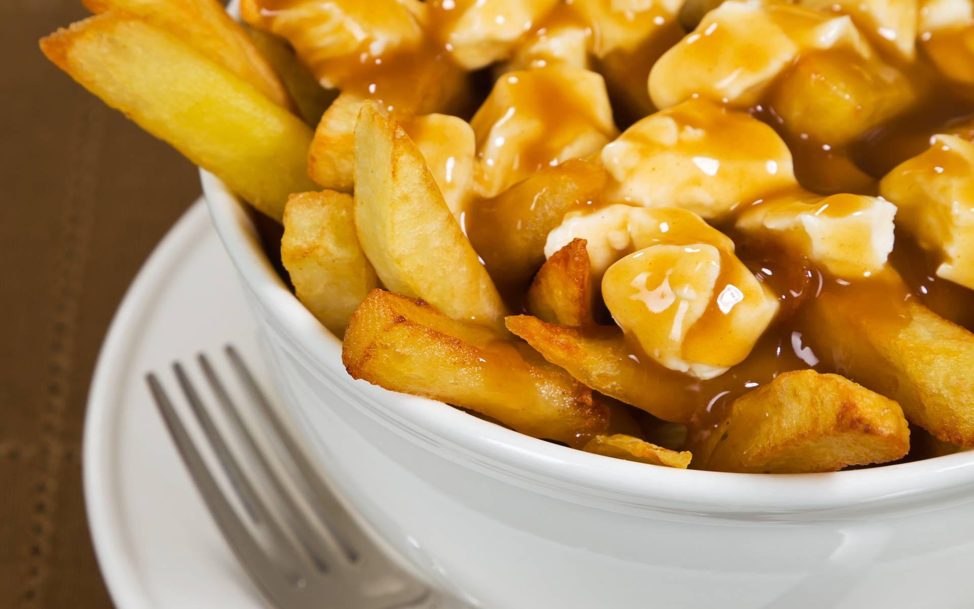 Delicious Poutine Dish In Close-up View Background