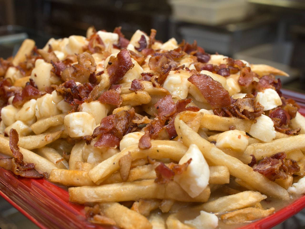 Delicious Poutine With Cheese Curds And Bacon Bits Background