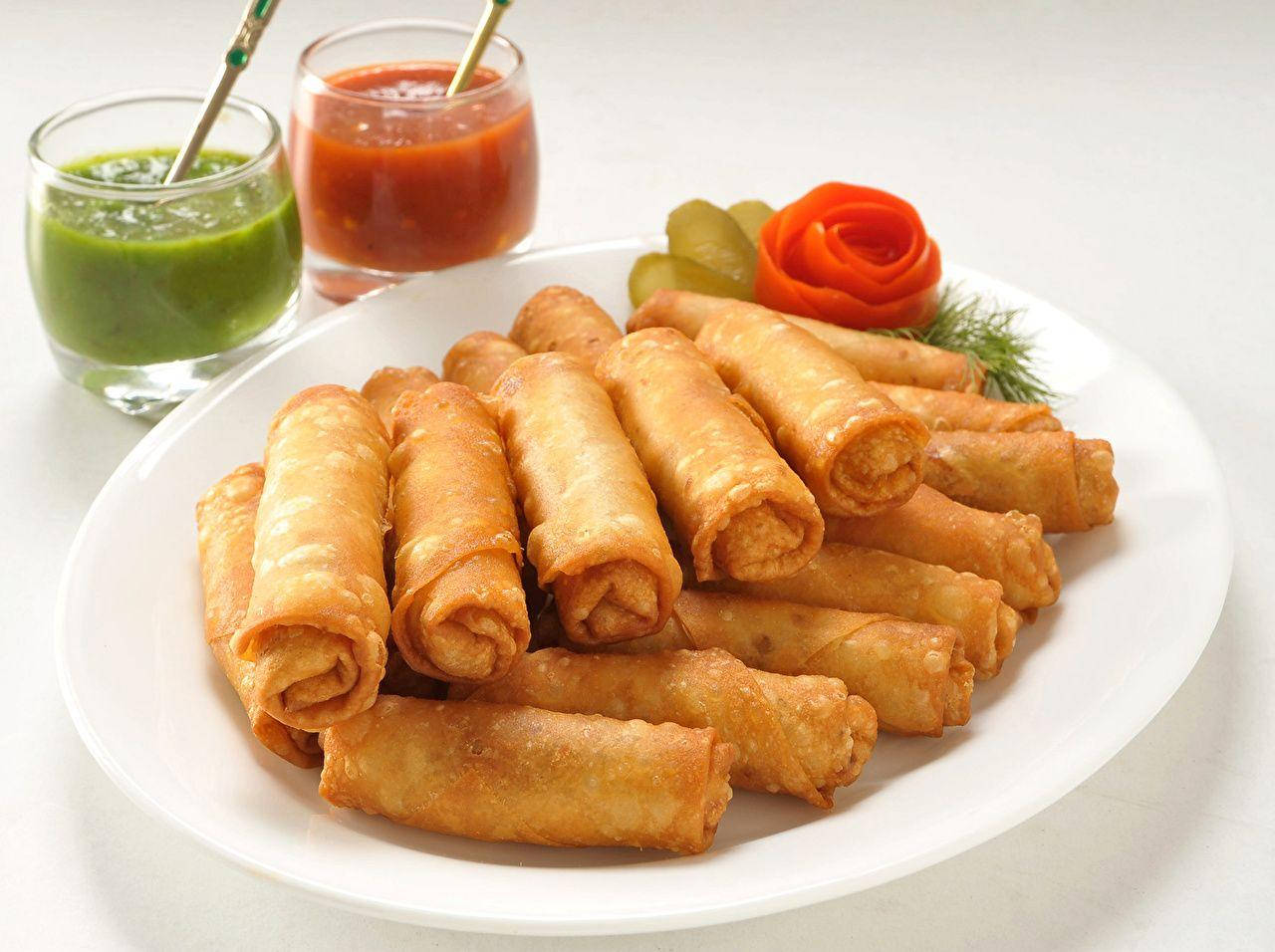 Delicious Stack Of Egg Rolls With Salsa Dips