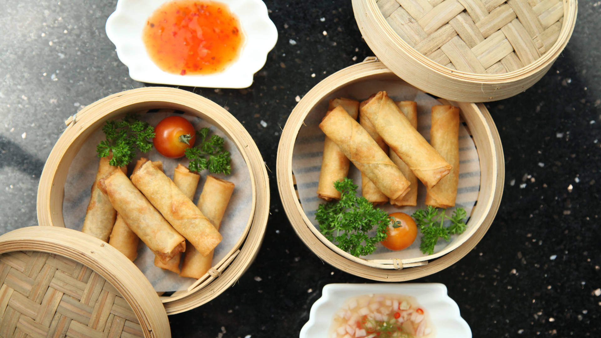 Delicious Steaming Basket Of Egg Rolls Background