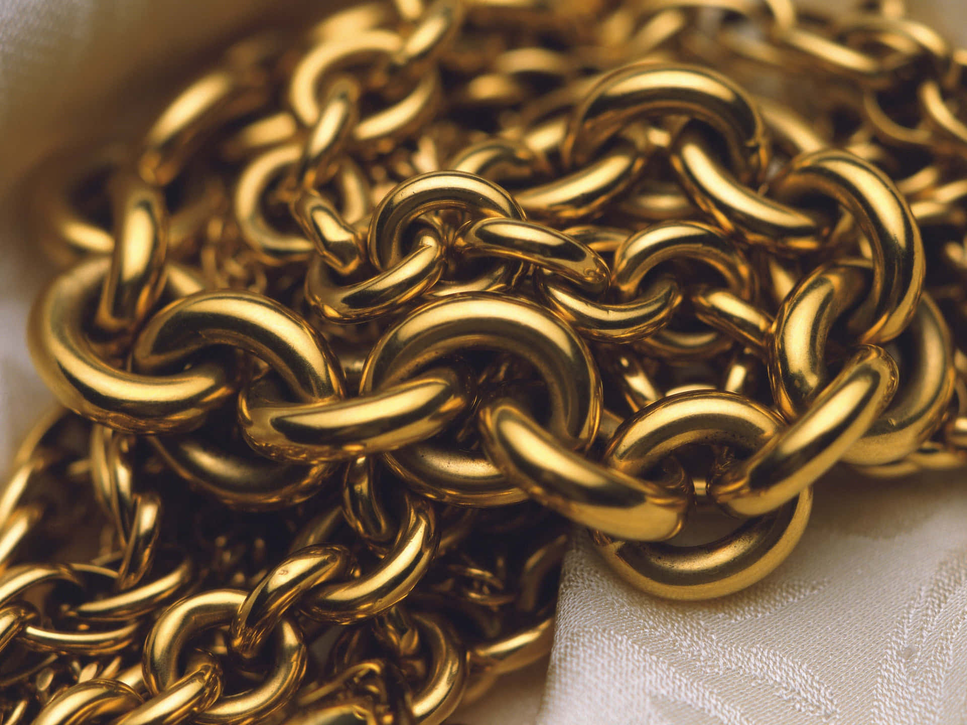 Delight In The Luxurious Shine Of A Gold Chain Background