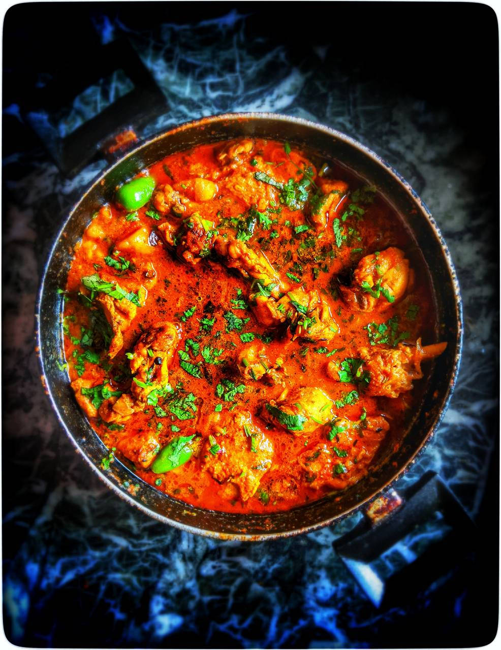 Delightful Butter Chicken Garnished With Fresh Herbs Background