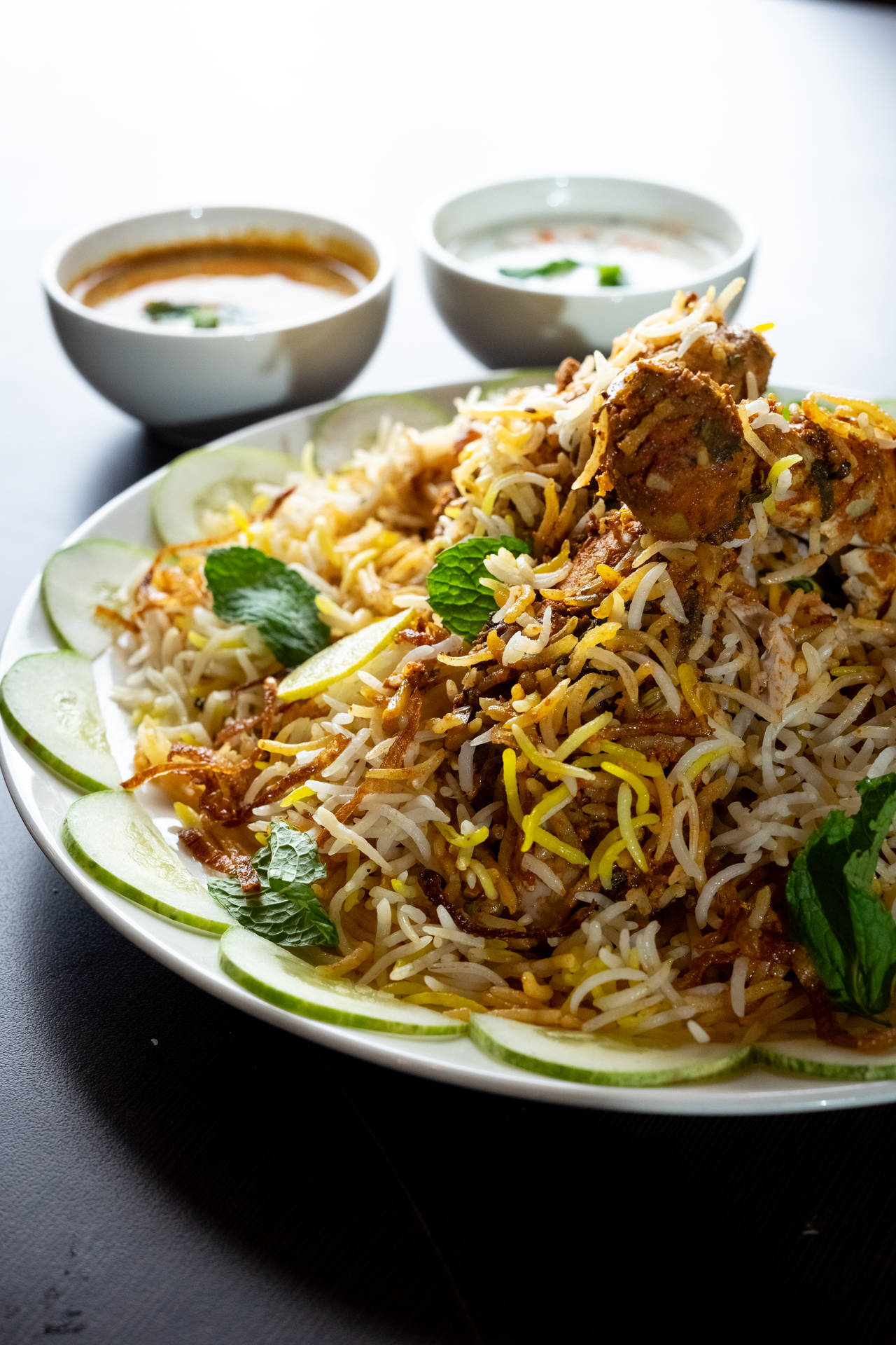 Delightful Chicken Biryani Garnished With Fresh Cucumbers