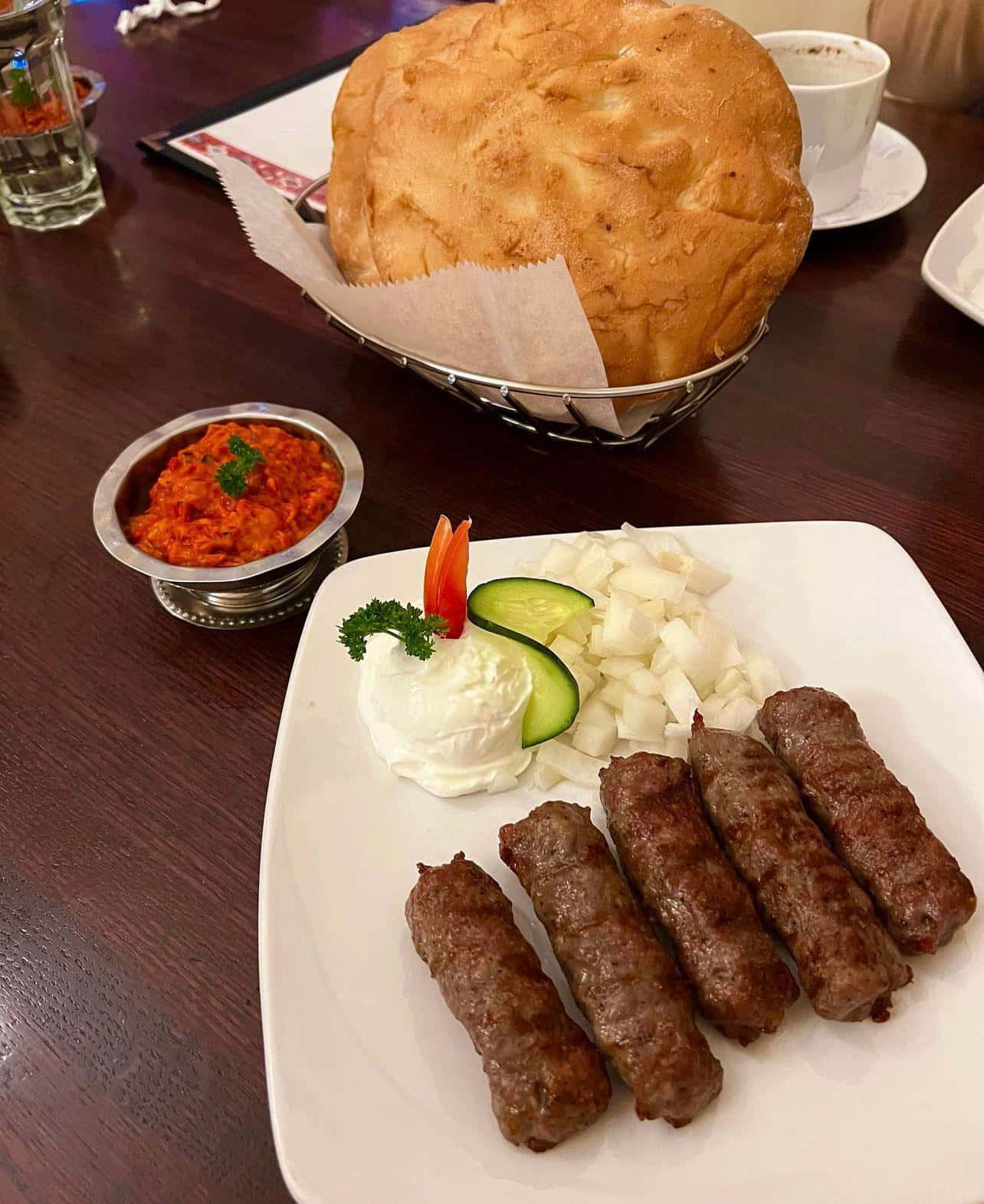 Delightful Dish Of Ćevapi Sausages And Fresh Pita Bread Background