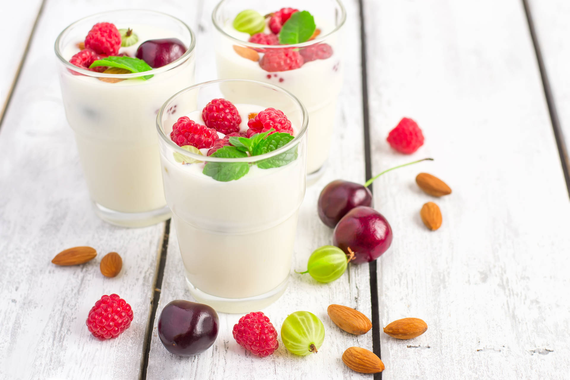 Delightful Mix Of Yogurt With Berries And Almonds Background