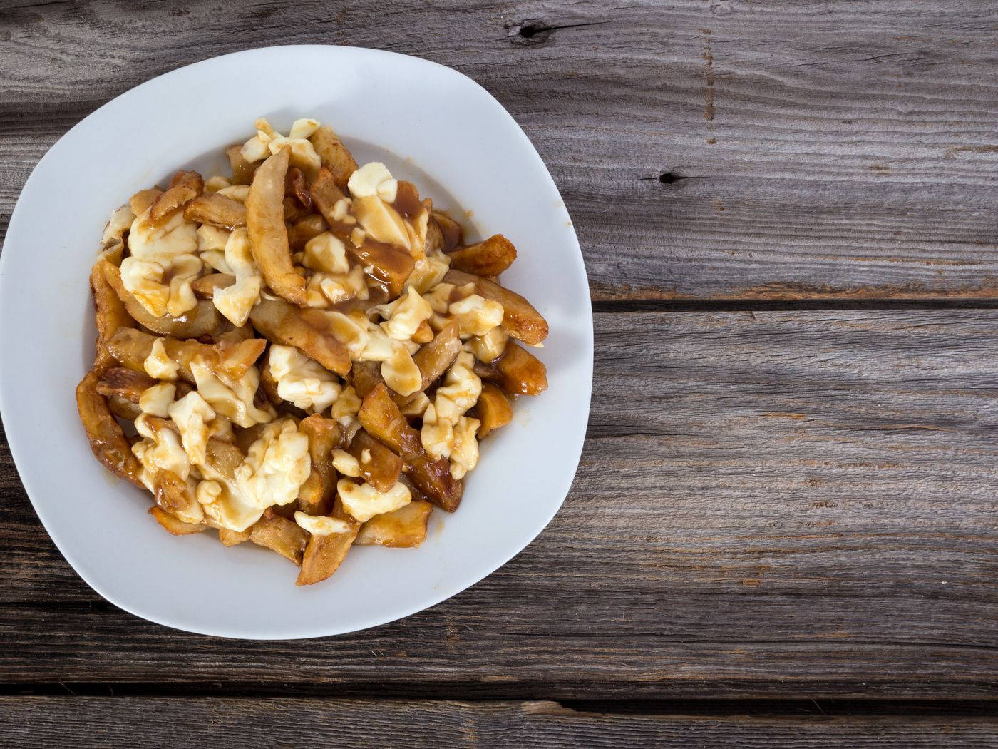 Delightful Plate Of Authentic Poutine Background