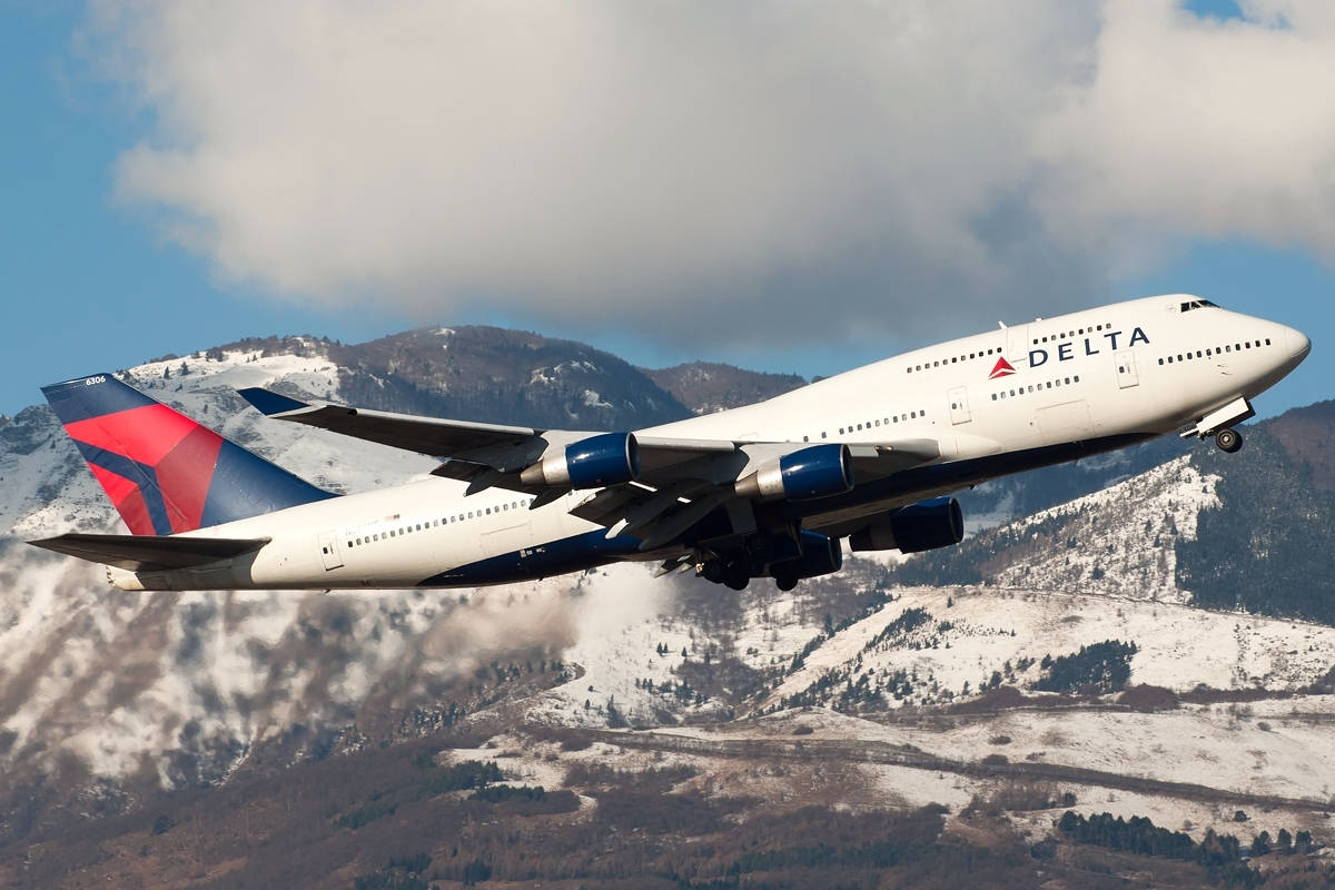 Delta Airlines Airplane Flying By Mountains