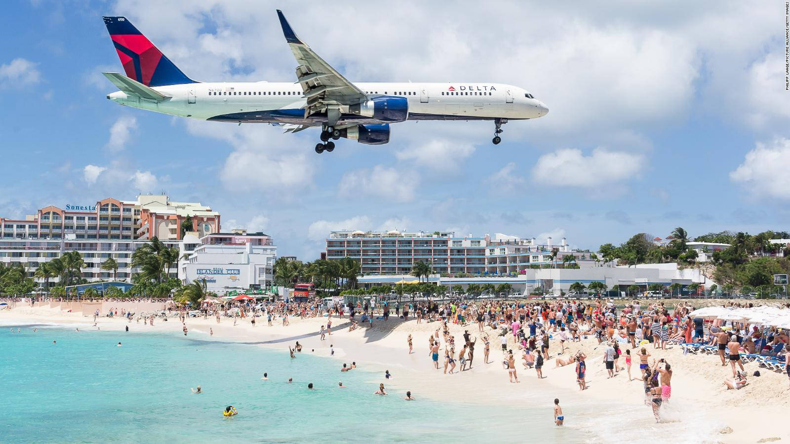 Delta Airlines Flying Over A Beach In Sint Maarten Background