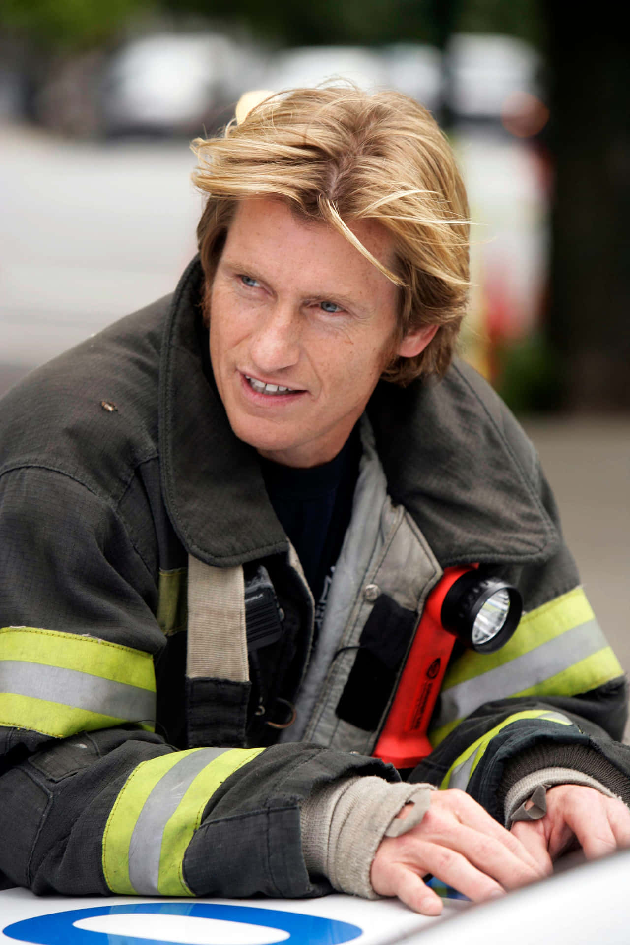 Denis Leary Pondering In Black And White Background