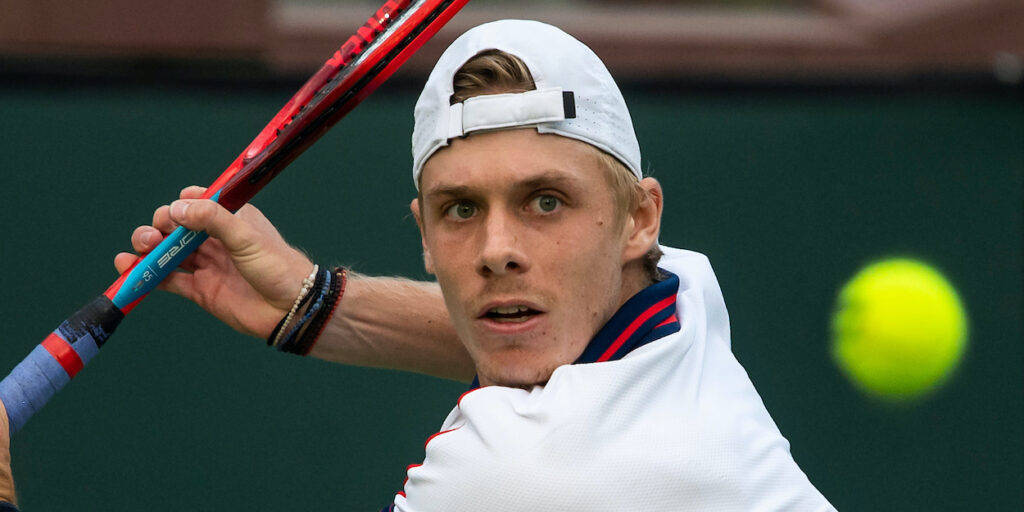 Denis Shapovalov In Focus During A Tennis Match Background