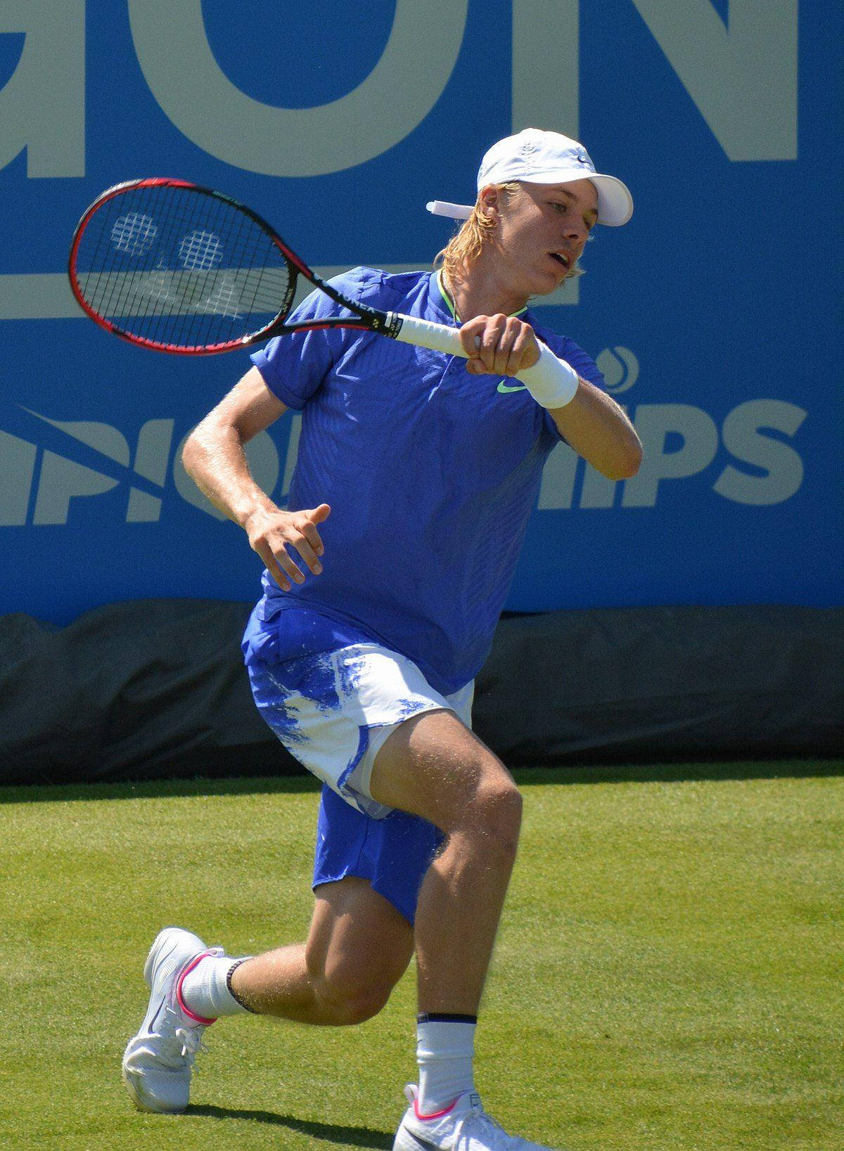 Denis Shapovalov Swinging Racket Background