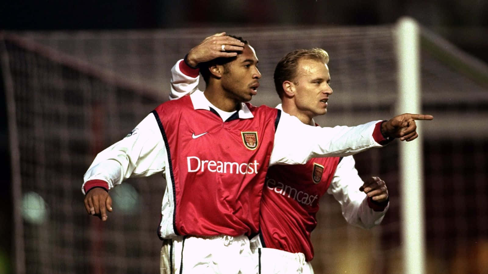 Dennis Bergkamp And Thierry Henry Showcasing Skills During Match With Derby County Background