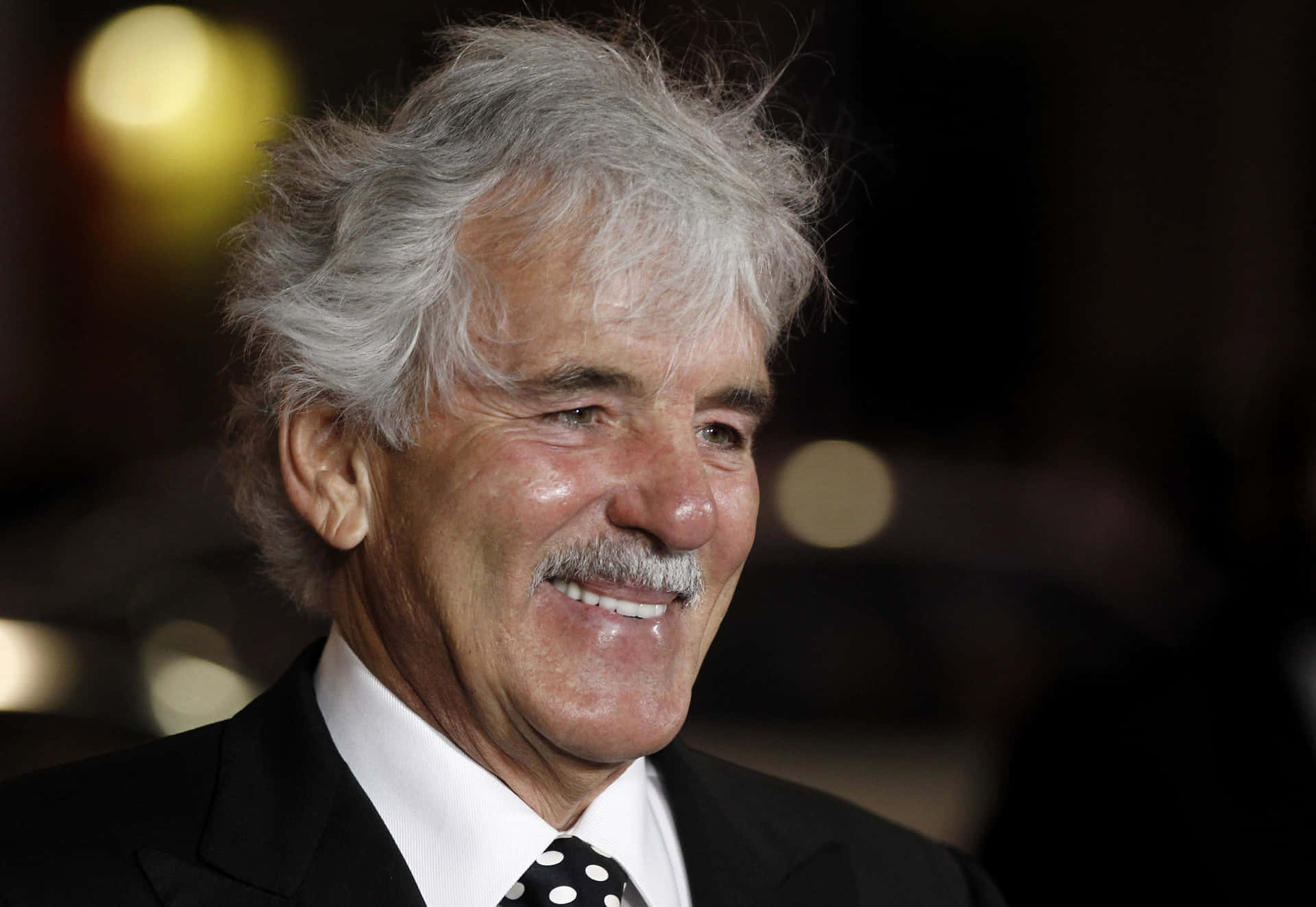Dennis Farina Posing For A Photoshoot Background