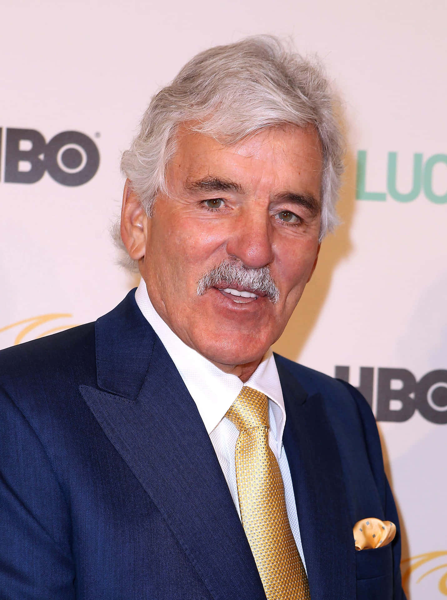 Dennis Farina, The Legendary Actor, Posing For A Photoshoot Background
