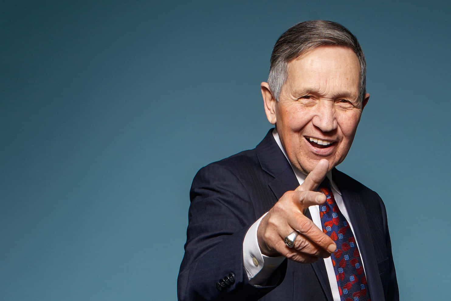 Dennis Kucinich Pointing A Hand Forward Background