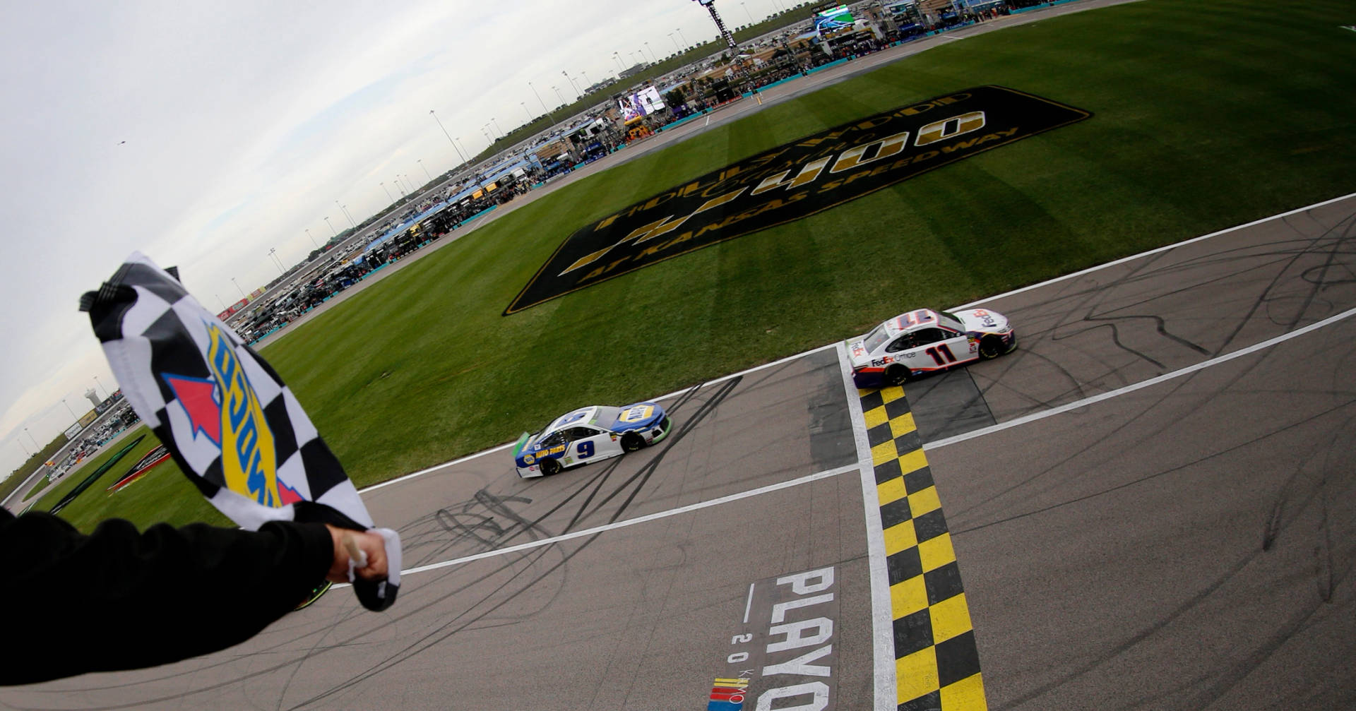 Denny Hamlin Passing The Finish Line Background