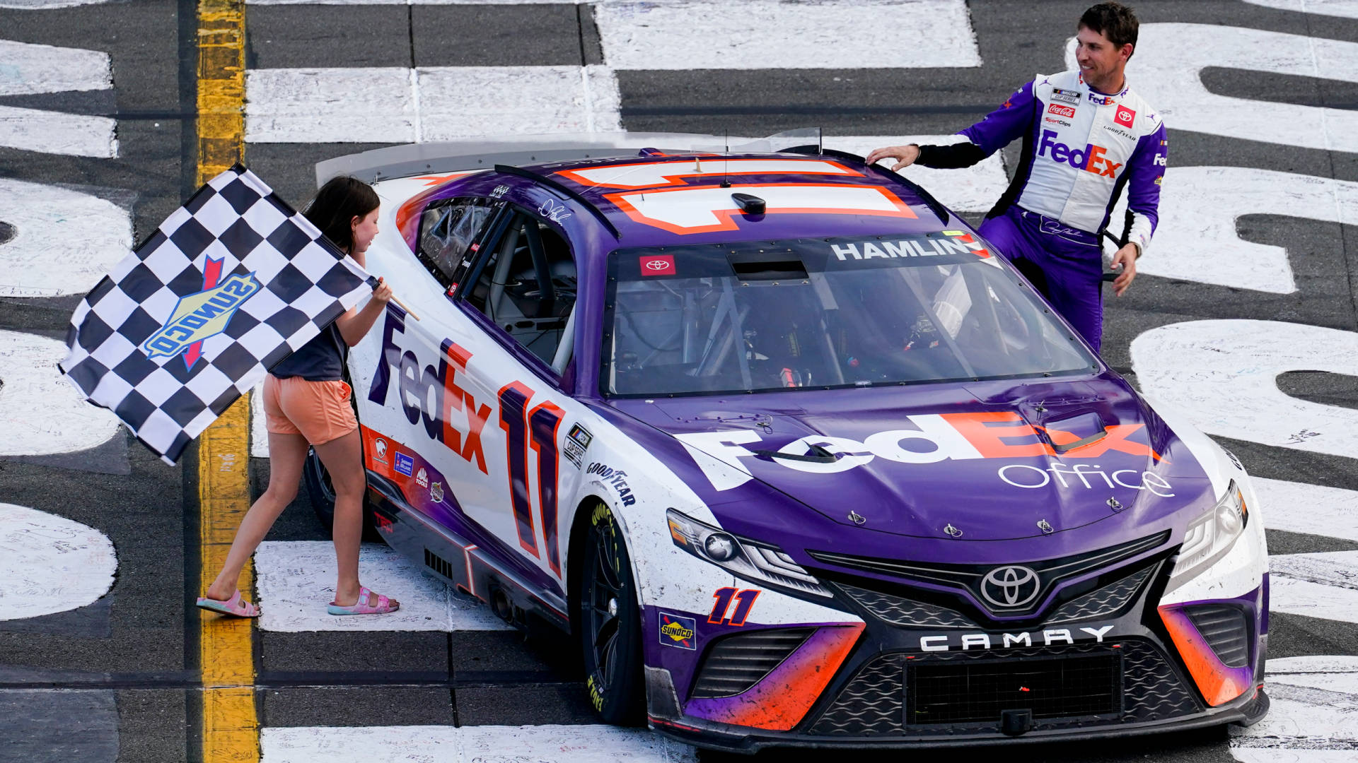 Denny Hamlin Posing With A Young Fan Background