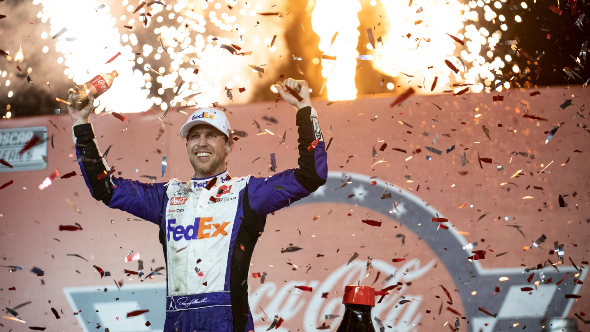 Denny Hamlin Surrounded By Confetti Background