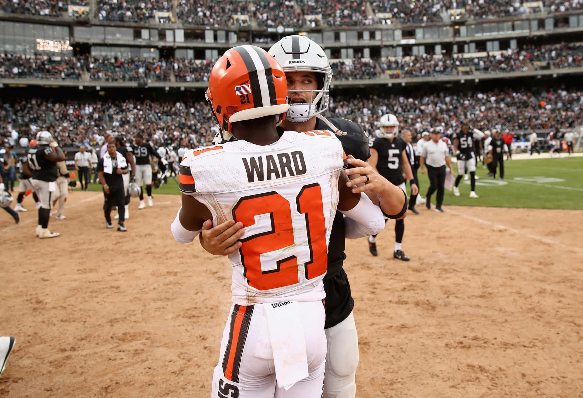 Denzel Ward And Odell Beckham Jr. Hug Background