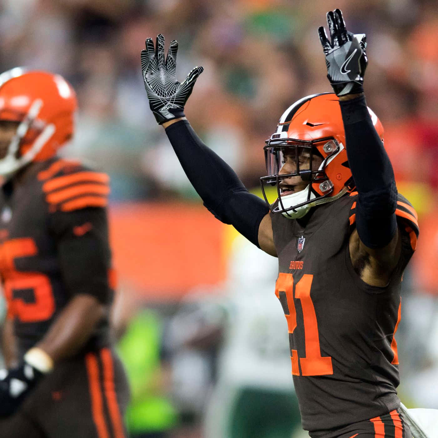 Denzel Ward Celebrates Against New York Jets Background