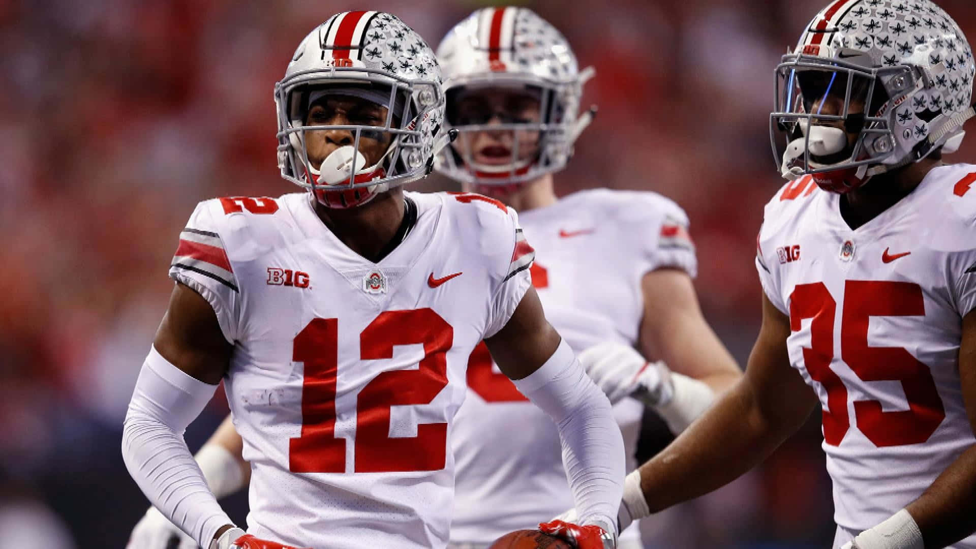 Denzel Ward Celebrates Against Wisconsin Badgers Background