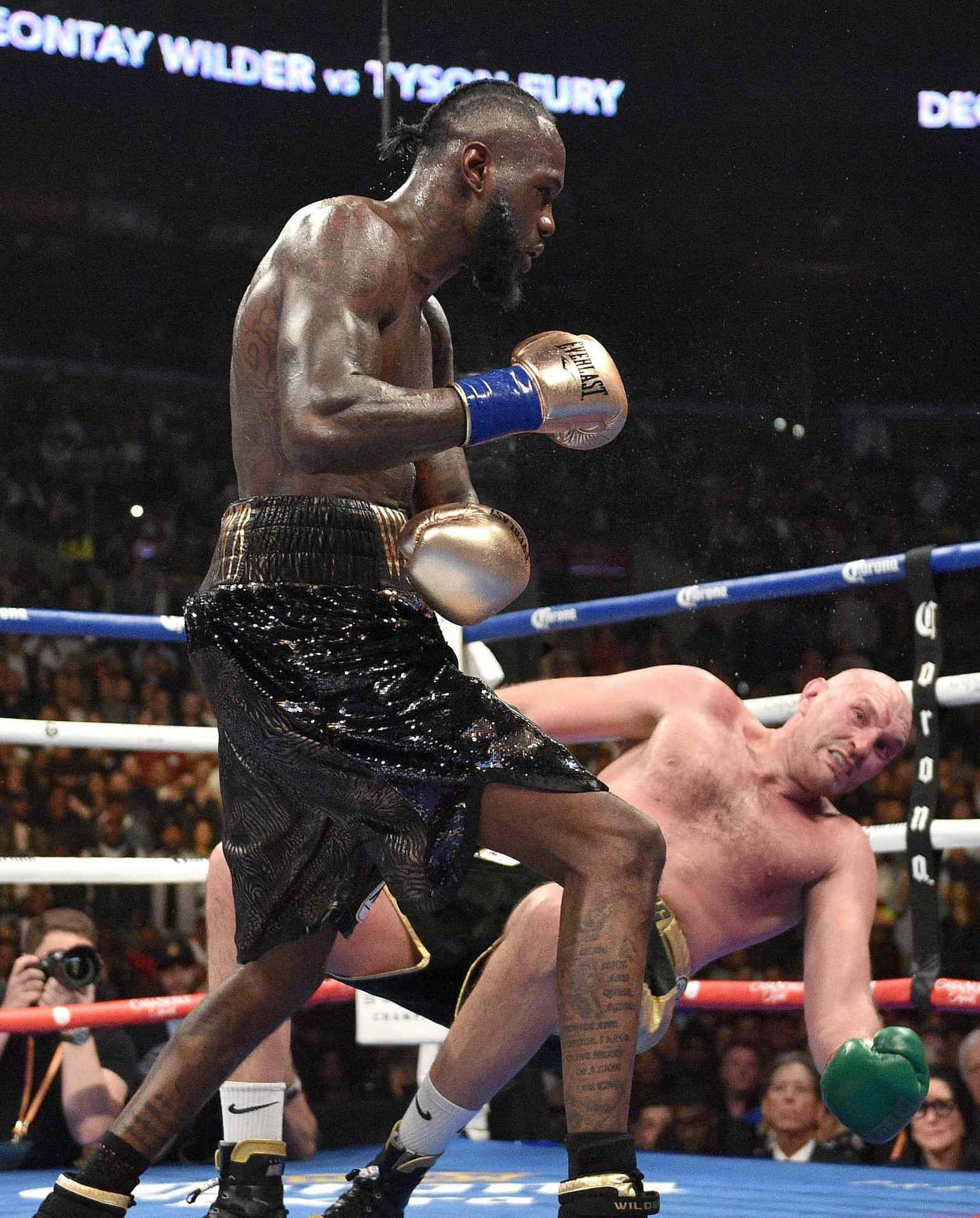 Deontay Wilder Knockdownin Boxing Match Background