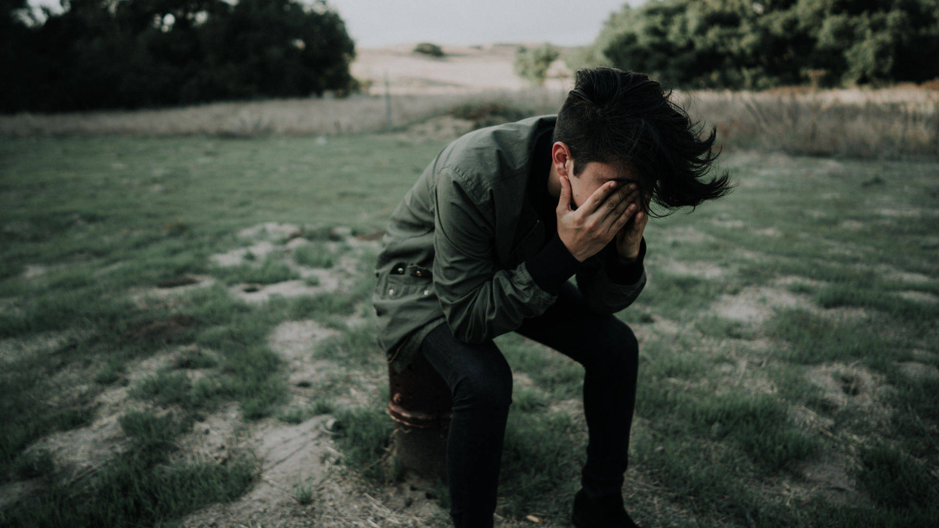 Depicting Desolation: Solitary Man In Contemplation Background