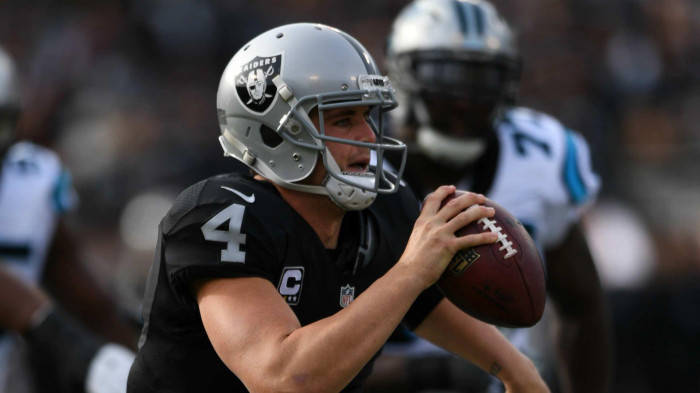 Derek Carr Holds The Football With One Hand