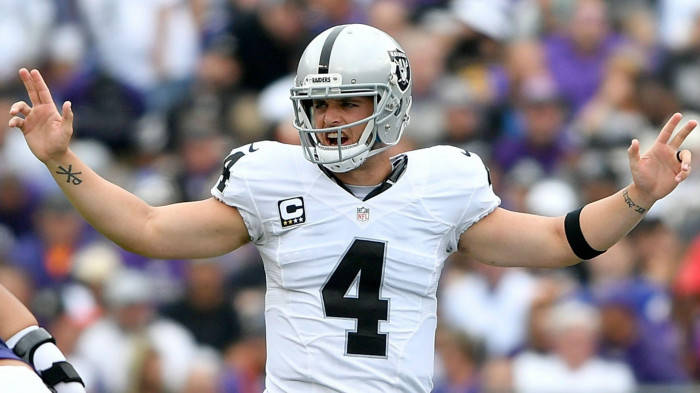 Derek Carr In White Raising His Arms